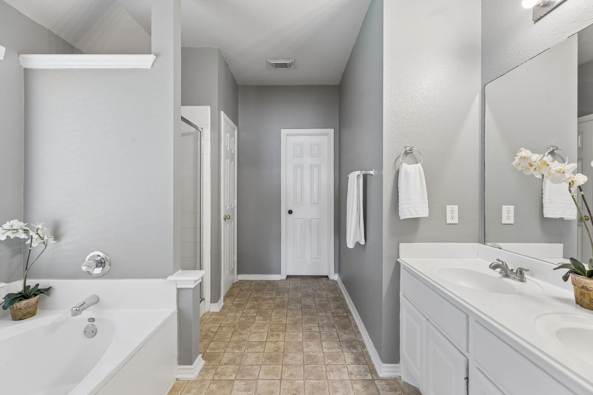 159 Invierno Street Kyle, TX 78640 - Photo 24 of 40 The primary ensuite bathroom features a relaxing built-in soaking tub, separate shower, private toilet, and a walk-in closet.