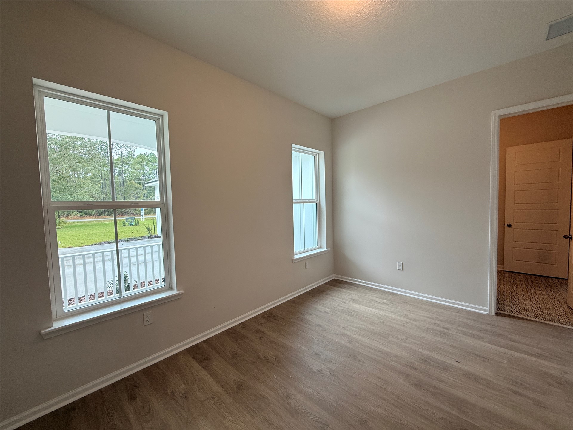 96342 Blackrock Road Yulee, FL 32097 - Photo 11 of 23 a view of an empty room with wooden floor and a window
