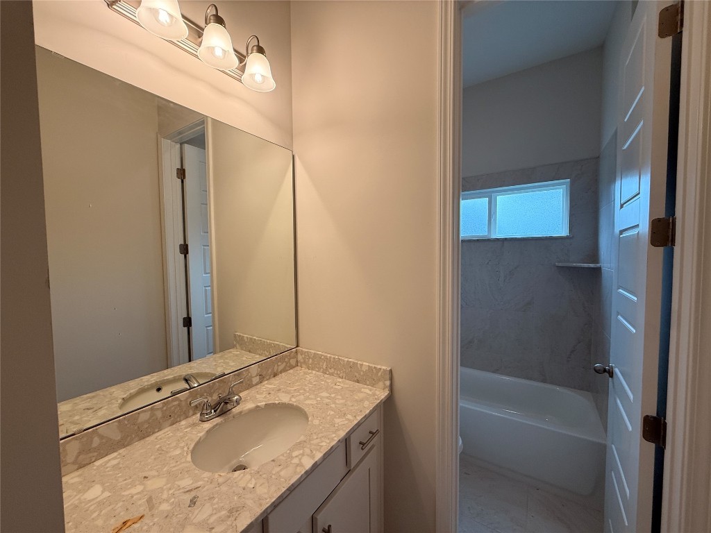 96342 Blackrock Road Yulee, FL 32097 - Photo 14 of 23 a bathroom with a granite countertop sink mirror vanity and bathtub