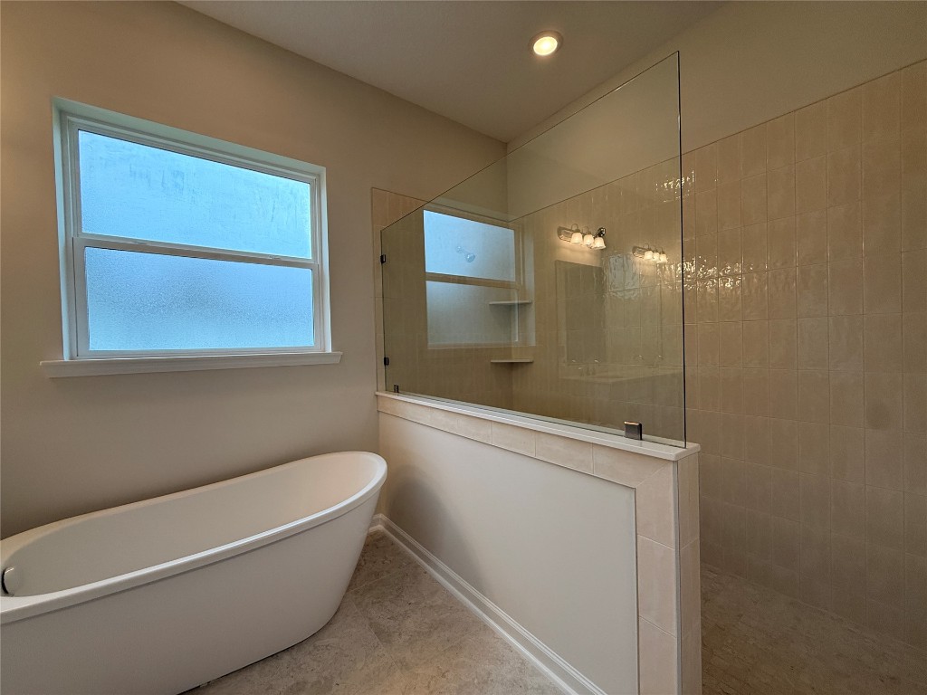 96342 Blackrock Road Yulee, FL 32097 - Photo 19 of 23 a bathroom with a bathtub and a shower