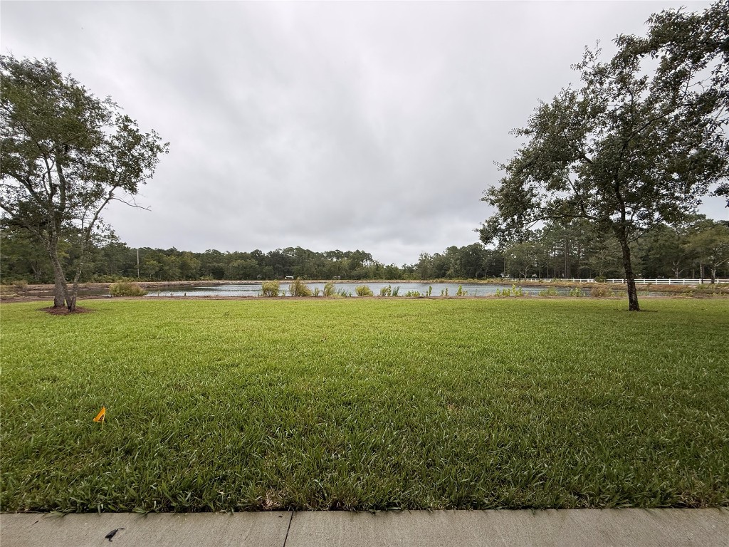 96342 Blackrock Road Yulee, FL 32097 - Photo 22 of 23 a view of a lake with houses in the background