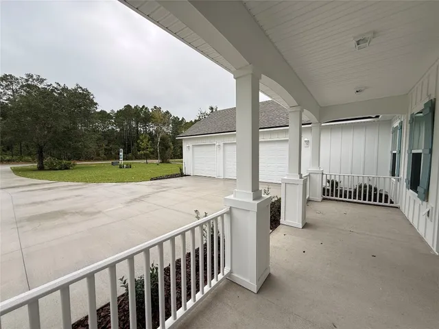a view of a porch with wooden floor and fence