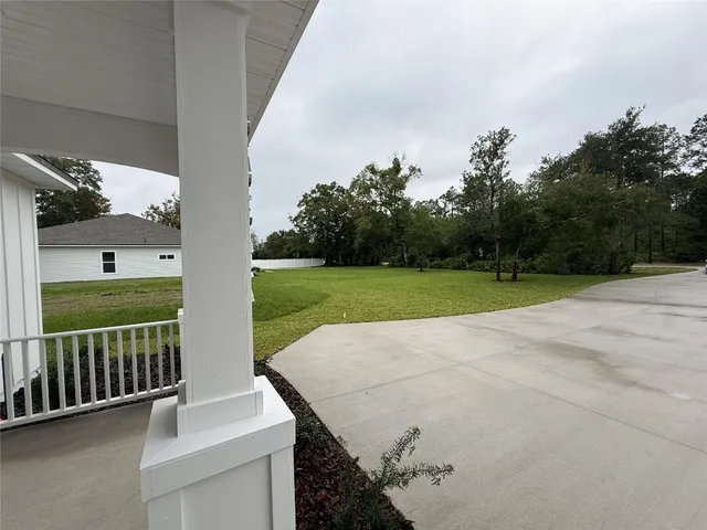 a view of a patio with a yard