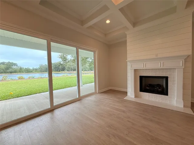 a view of an empty room with a fireplace and a floor to ceiling window