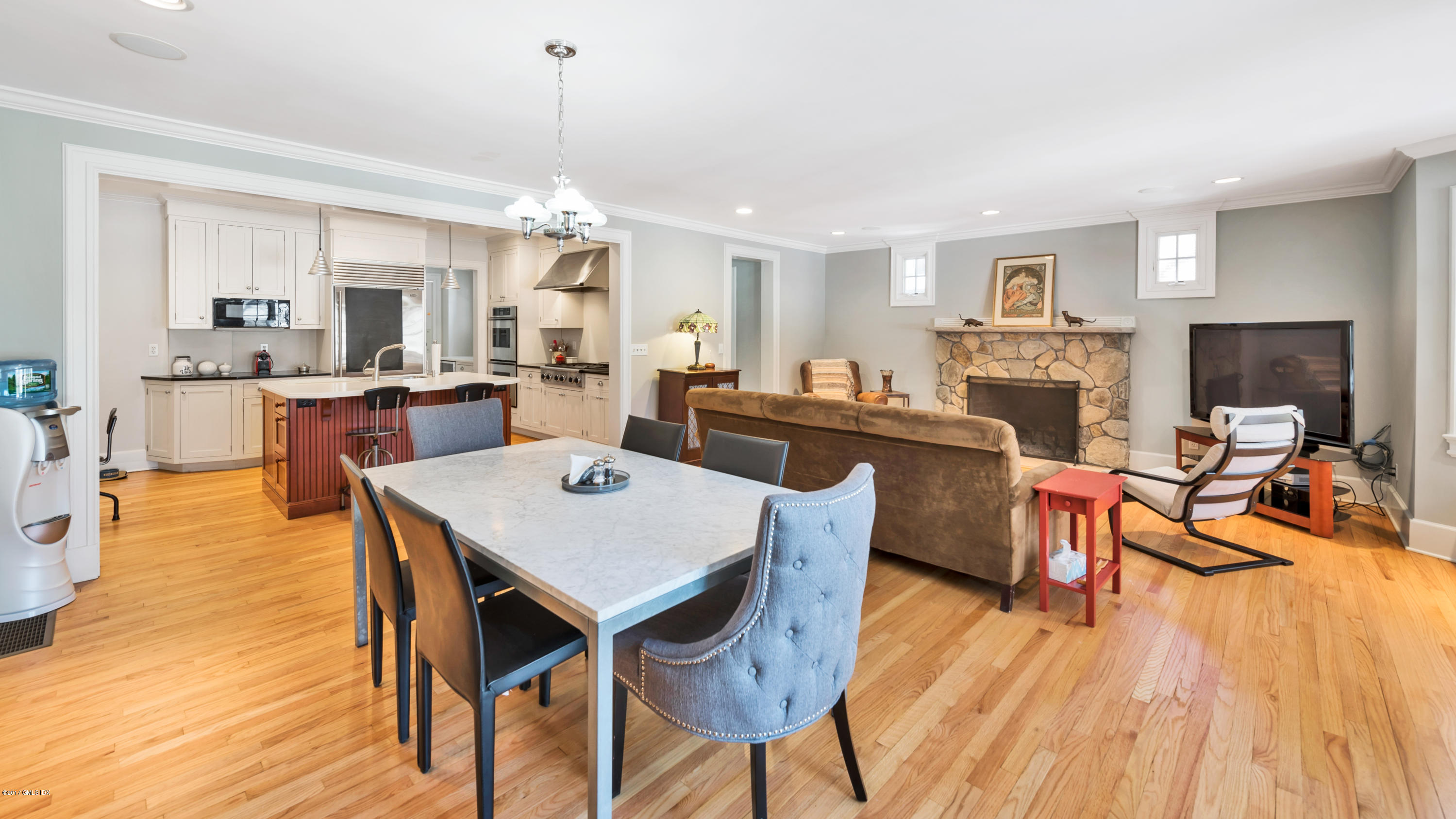 57 Indian Field Road Greenwich, CT 06830 - Photo 12 of 24 a view of a dining room with furniture a chandelier and wooden floor
