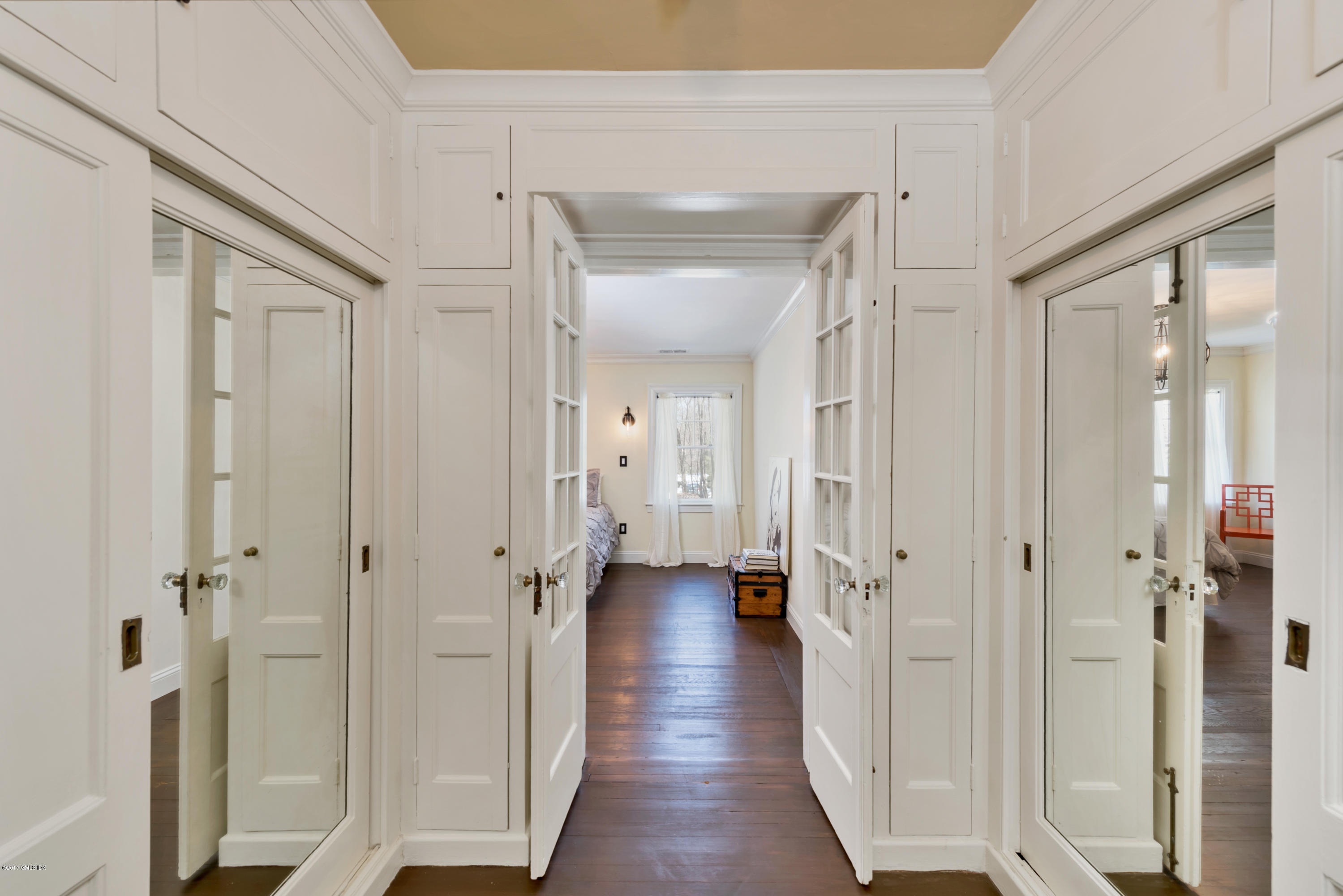 57 Indian Field Road Greenwich, CT 06830 - Photo 18 of 24 a view of a hallway with wooden floor and a glass door