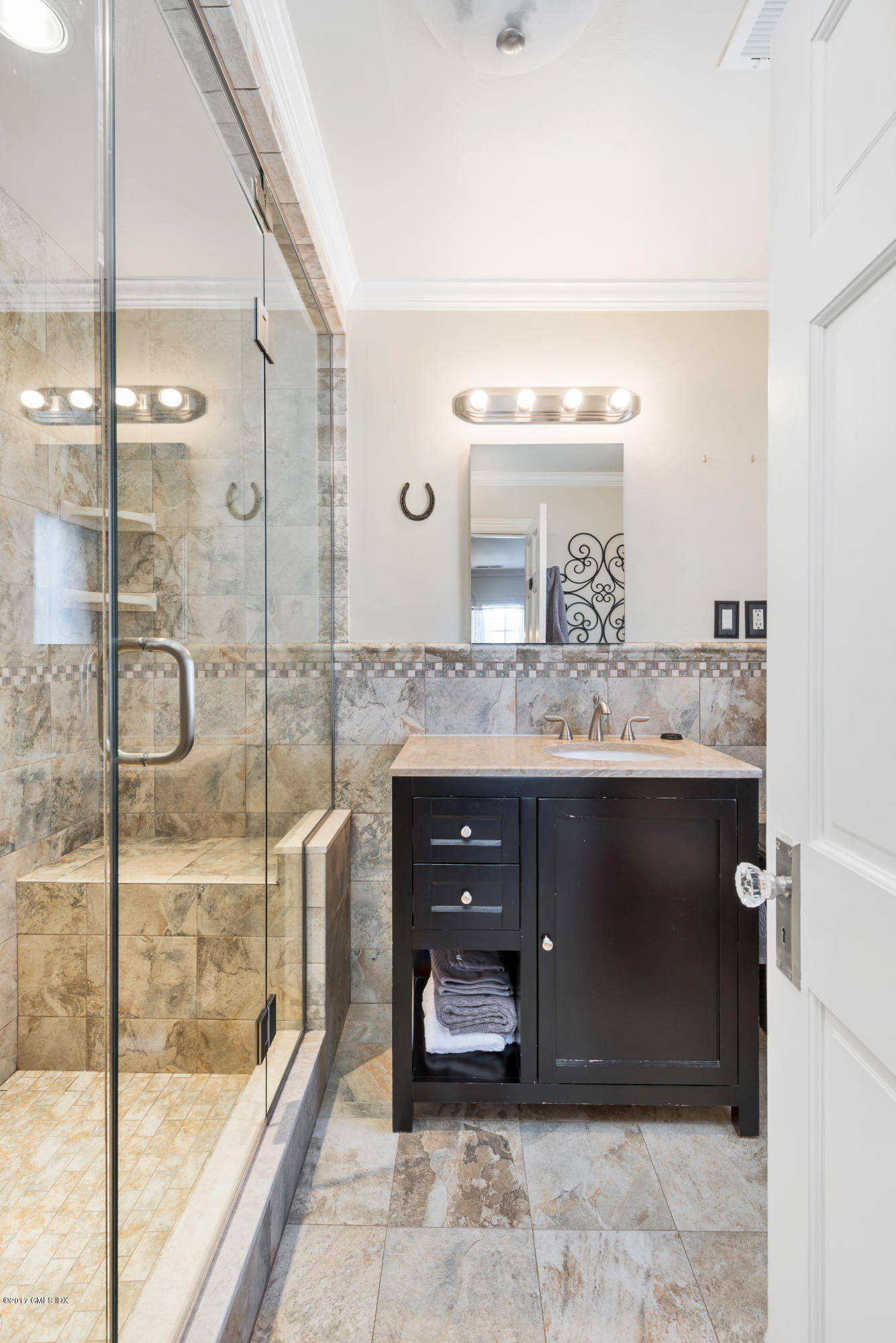 57 Indian Field Road Greenwich, CT 06830 - Photo 20 of 24 a bathroom with a granite countertop sink a mirror and shower
