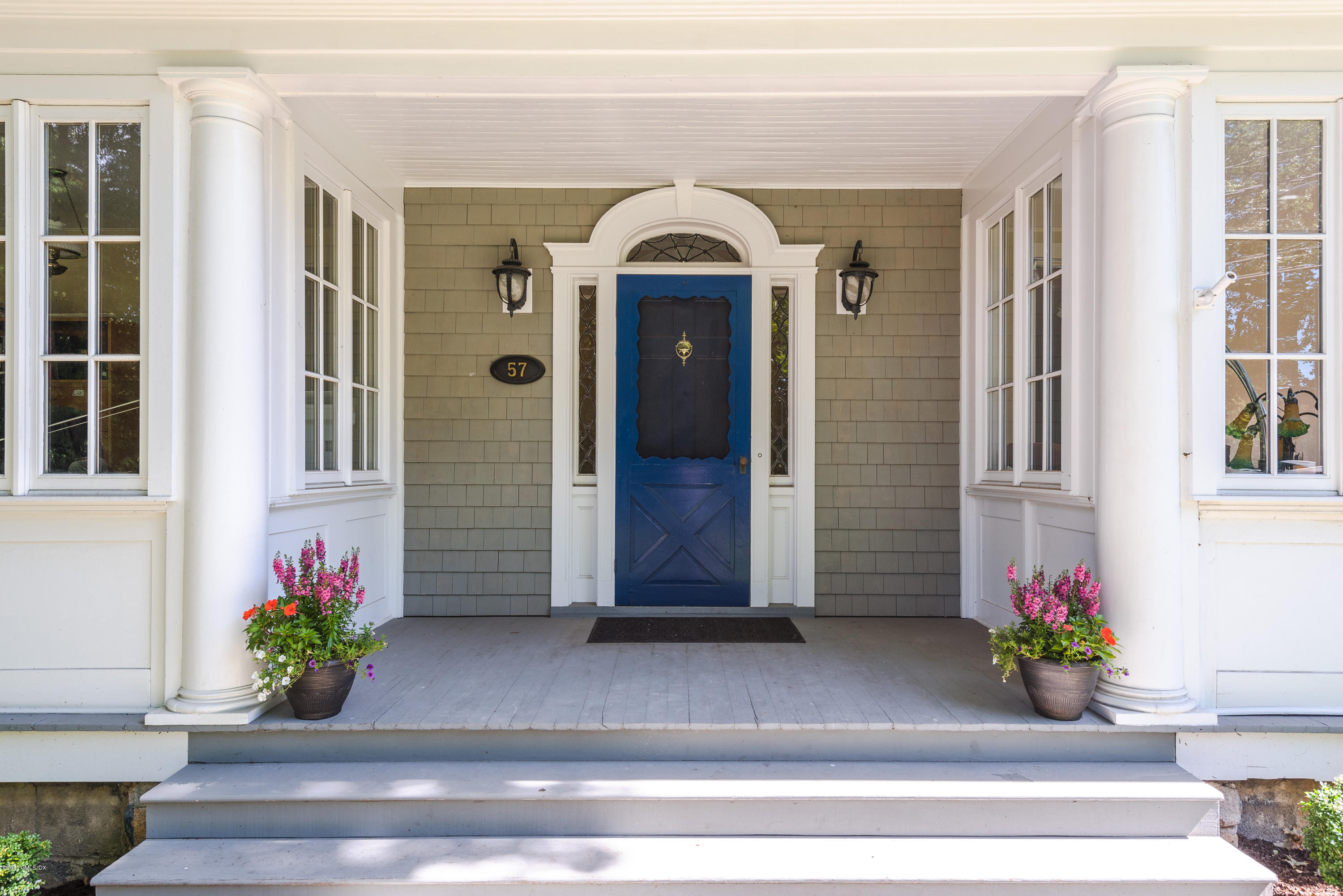57 Indian Field Road Greenwich, CT 06830 - Photo 3 of 24 a front view of a house with a garden