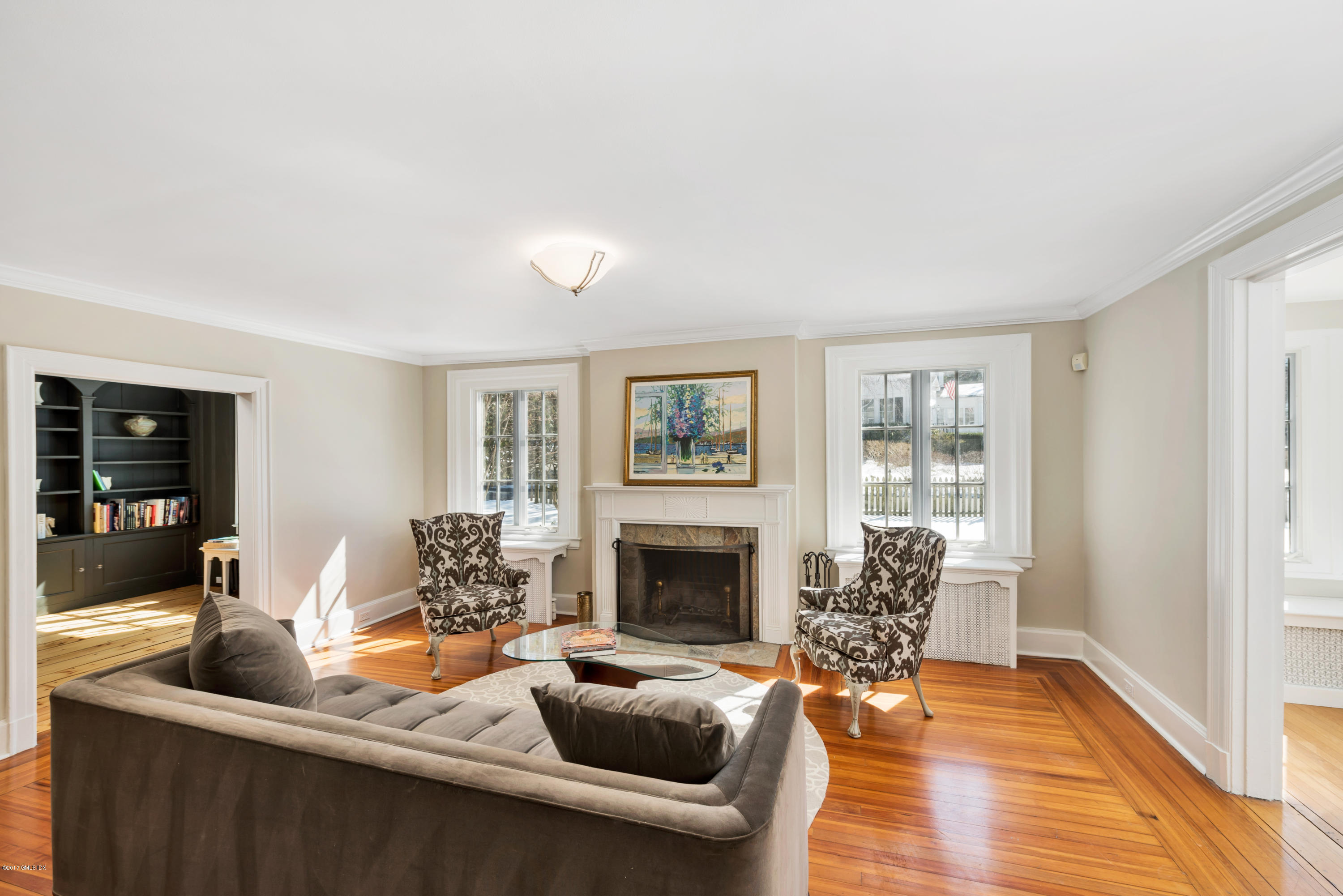 57 Indian Field Road Greenwich, CT 06830 - Photo 5 of 24 a living room with furniture a fireplace and a wooden floor
