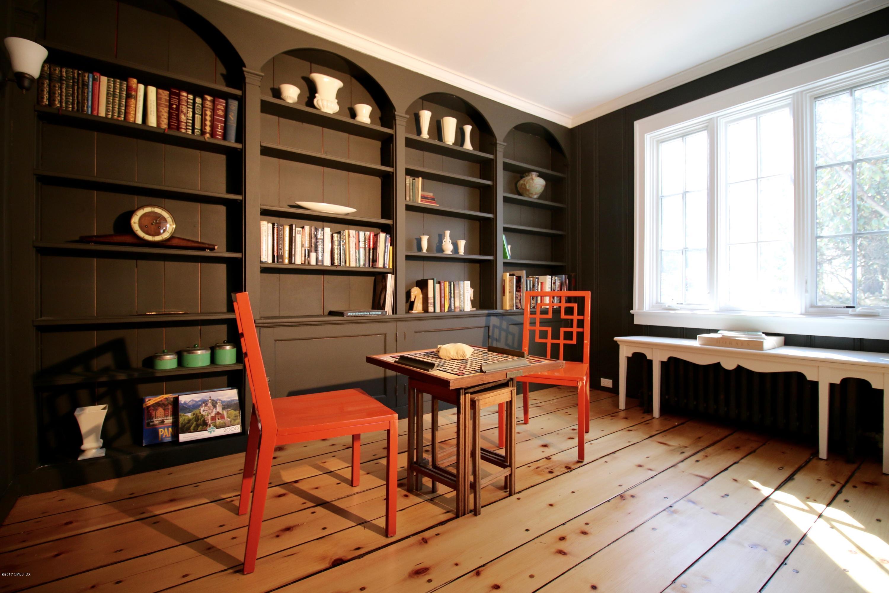 57 Indian Field Road Greenwich, CT 06830 - Photo 6 of 24 a view of a workspace with furniture and a book shelf