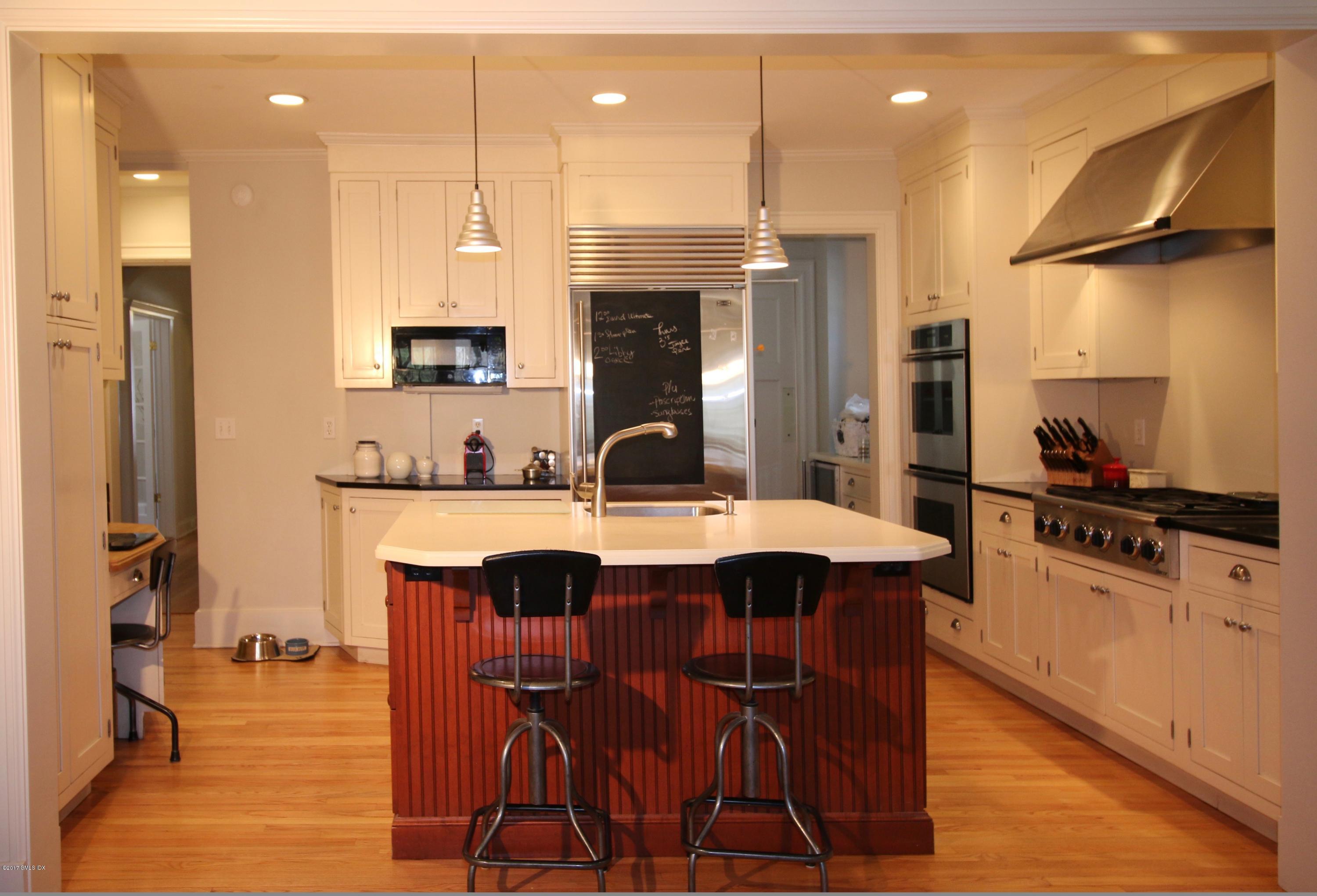 57 Indian Field Road Greenwich, CT 06830 - Photo 8 of 24 a kitchen with stainless steel appliances a sink stove and refrigerator