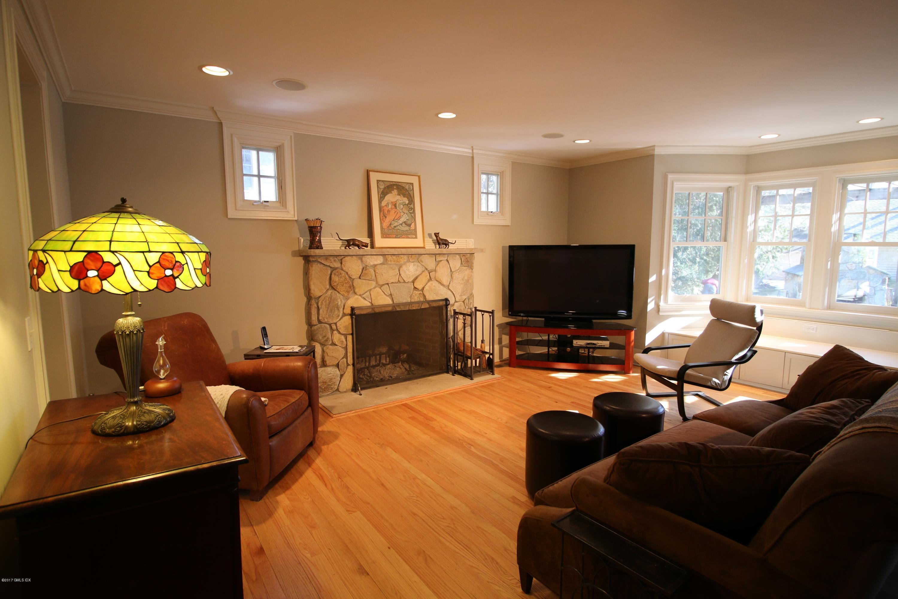 57 Indian Field Road Greenwich, CT 06830 - Photo 9 of 24 a living room with fireplace furniture and a flat screen tv