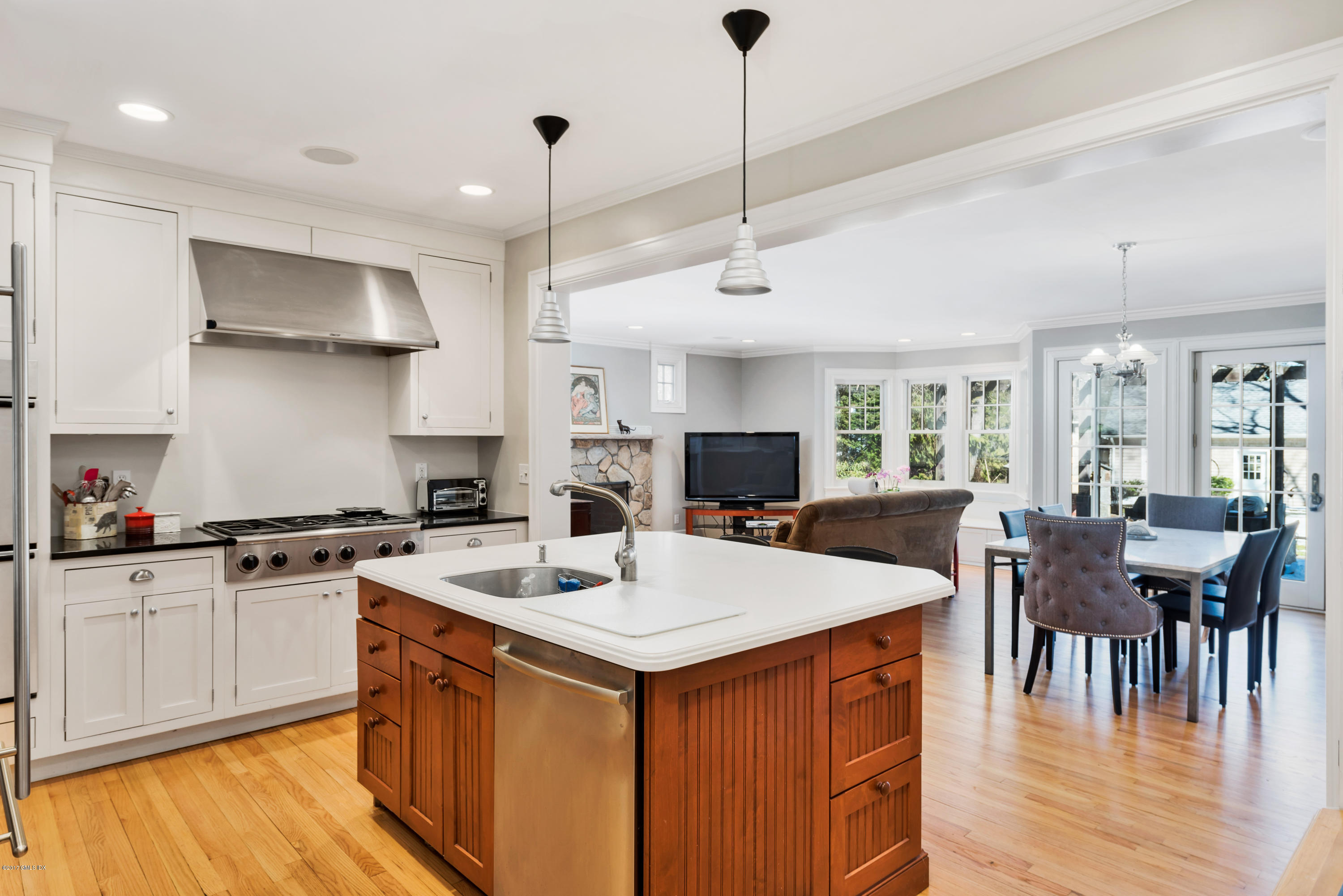 57 Indian Field Road Greenwich, CT 06830 - Photo 10 of 24 a kitchen with stainless steel appliances granite countertop a stove a sink a kitchen island with chairs and wooden floor