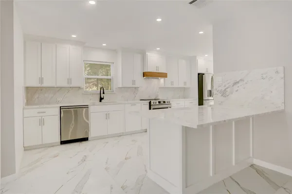 a kitchen with a sink a stove and cabinets