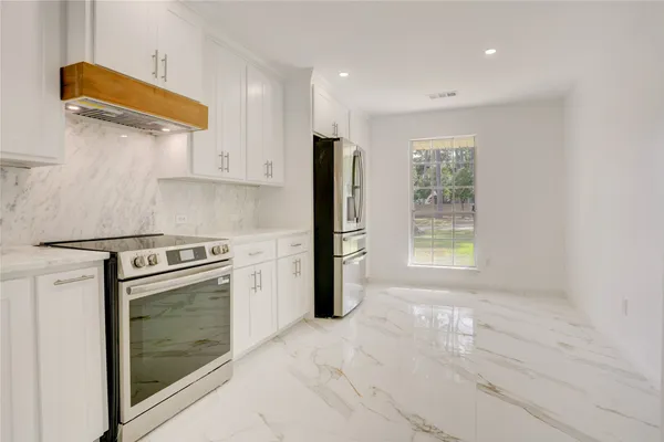 a kitchen with a stove a refrigerator and a sink