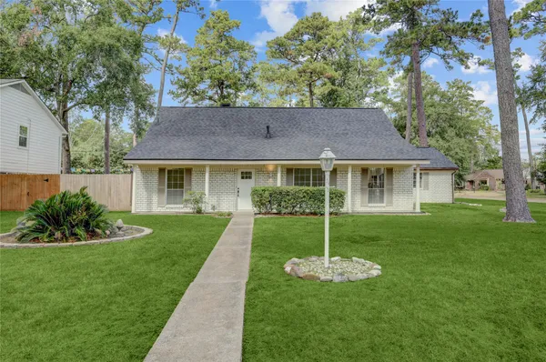 a view of a house with a yard and a garden