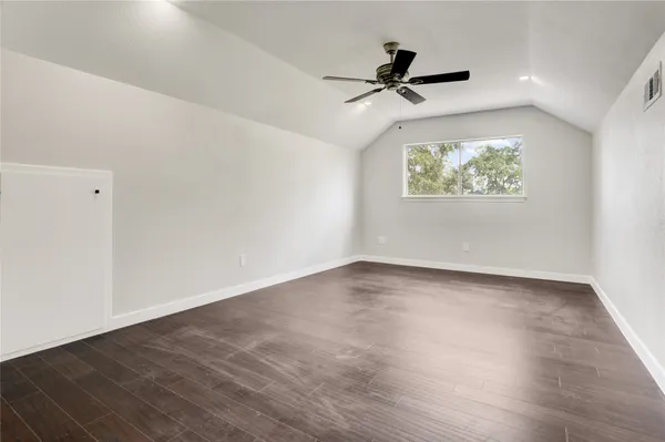 a view of an empty room with a painting on the wall