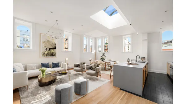 a living room with lots of furniture and wooden floor
