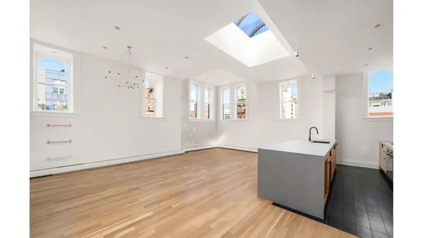 a view of kitchen and hall with wooden floor