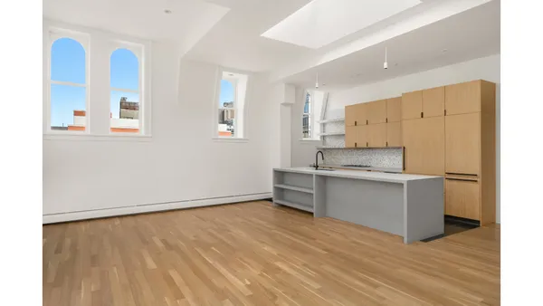 a kitchen with stainless steel appliances a refrigerator and a stove top oven