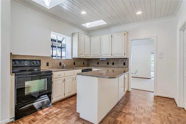 a kitchen with stainless steel appliances granite countertop a stove and a sink