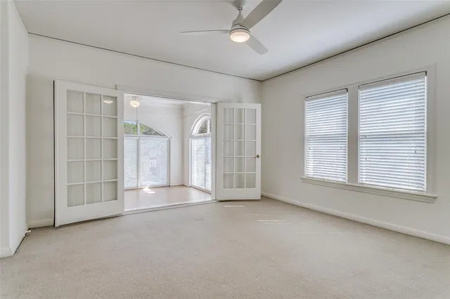 an empty room with windows and closet