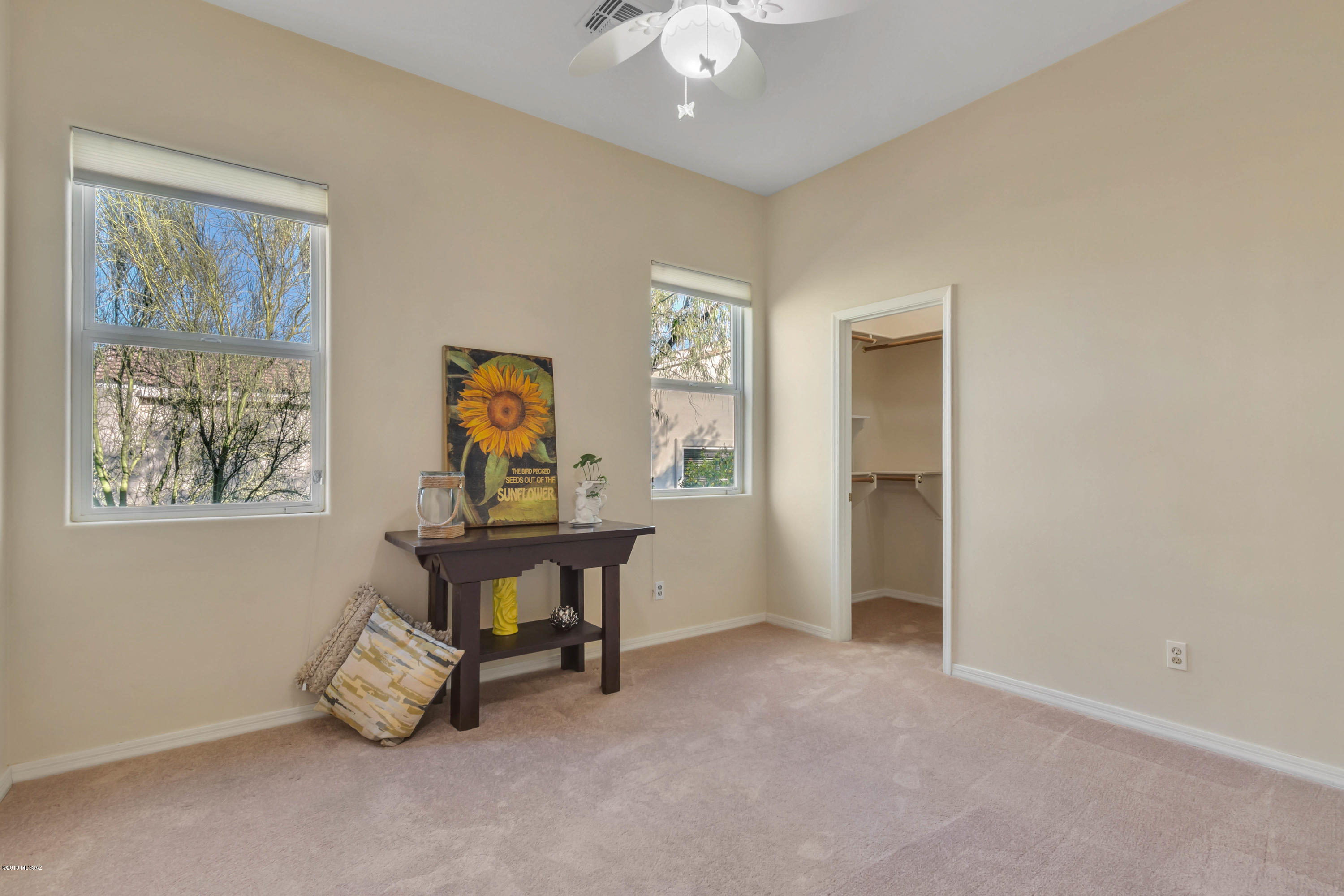 12682 North Spirit Mountain Road Oro Valley, AZ 85755 - Photo 9 of 40 a view of a workspace with furniture and a window