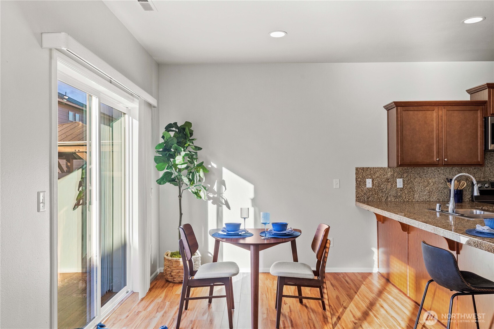 26219 243rd Place Southeast Maple Valley, WA 98038 - Photo 14 of 40 a view of a dining room with furniture and a potted plant