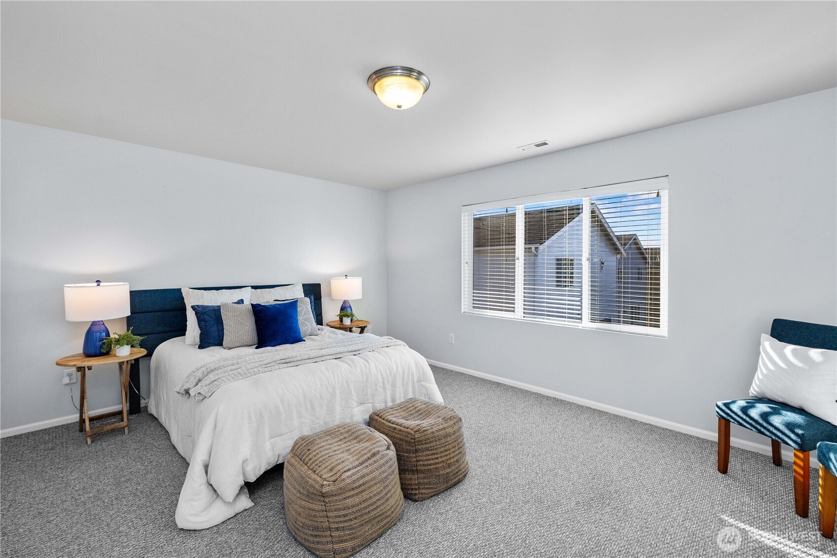 26219 243rd Place Southeast Maple Valley, WA 98038 - Photo 19 of 40 a bedroom with a bed and a chair