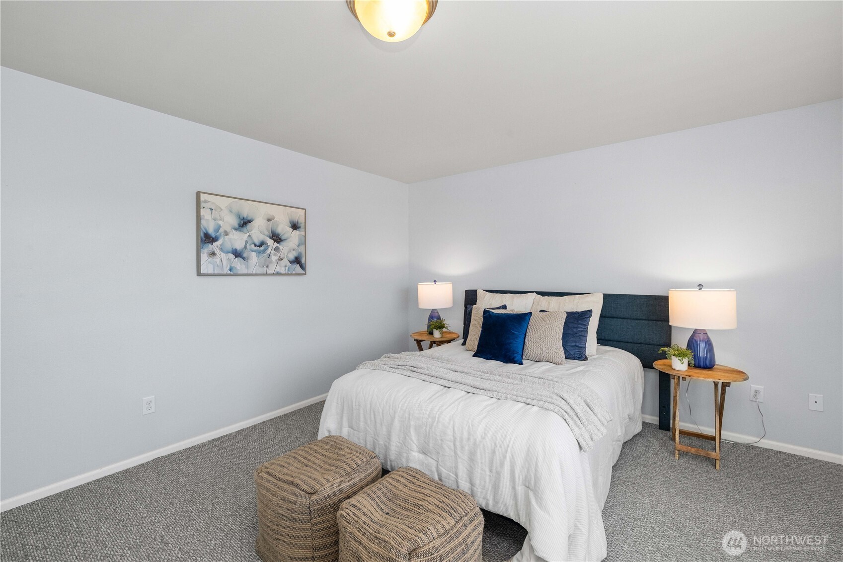 26219 243rd Place Southeast Maple Valley, WA 98038 - Photo 20 of 40 a bedroom with a bed and painting on the wall