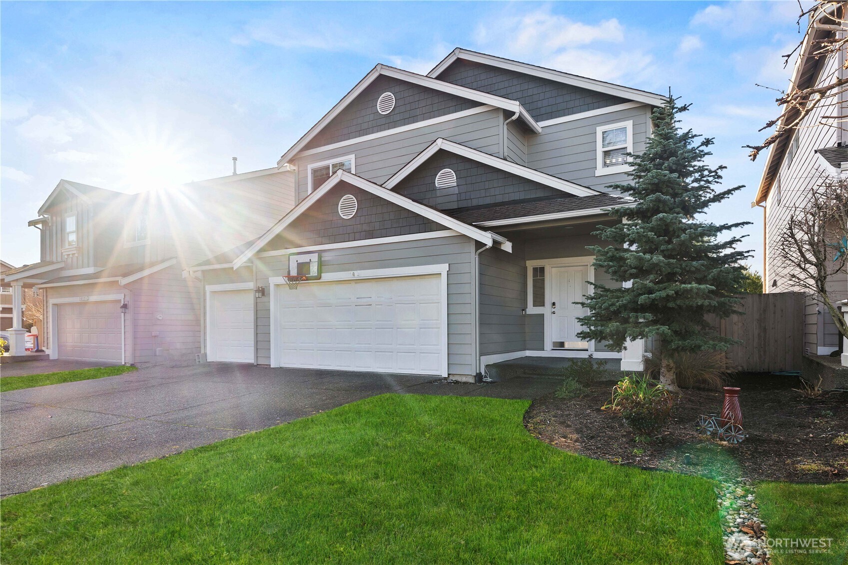 26219 243rd Place Southeast Maple Valley, WA 98038 - Photo 2 of 40 a front view of a house with a yard and garage