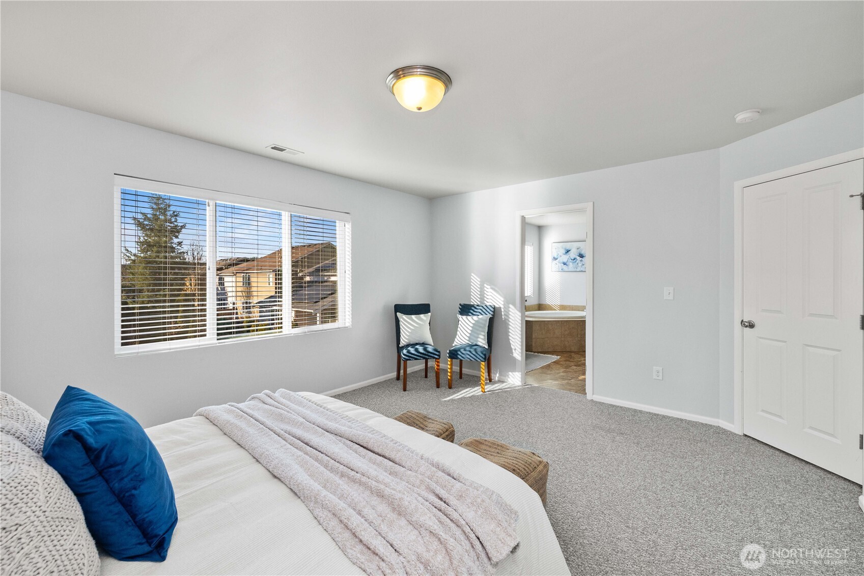 26219 243rd Place Southeast Maple Valley, WA 98038 - Photo 21 of 40 a bedroom with a bed and a chandelier