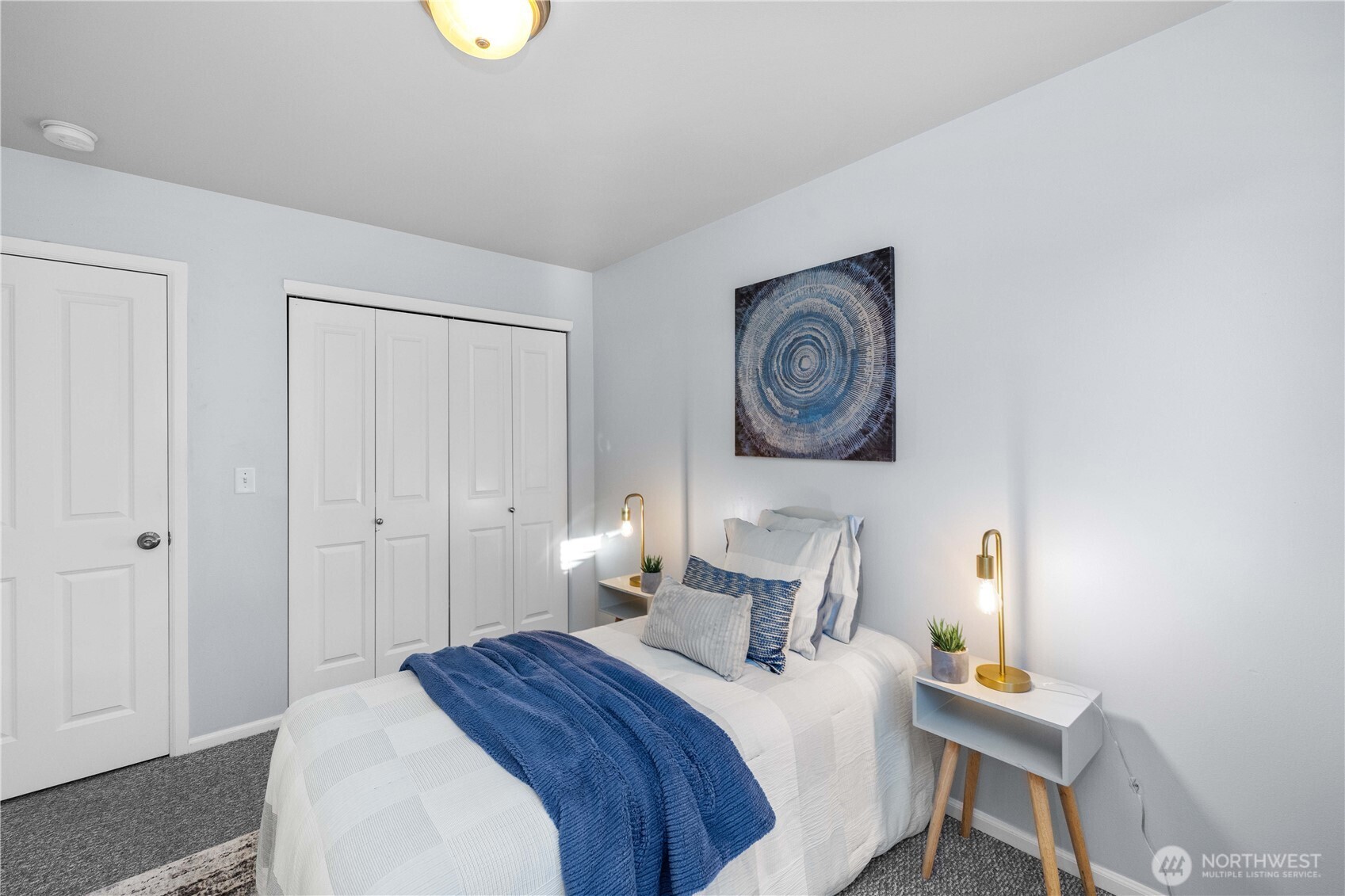 26219 243rd Place Southeast Maple Valley, WA 98038 - Photo 28 of 40 a bedroom with a bed and a lamp on dresser
