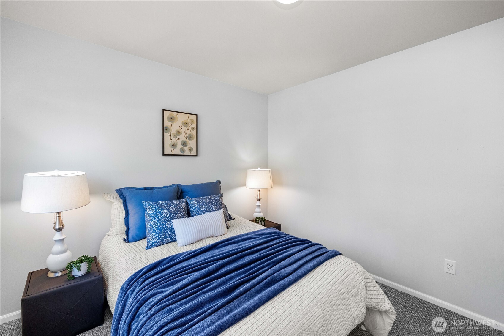 26219 243rd Place Southeast Maple Valley, WA 98038 - Photo 34 of 40 a bedroom with a bed and a lamp with the wooden floor