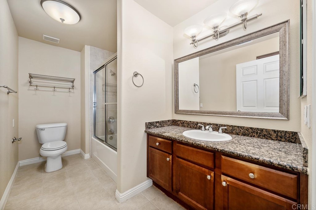 1434 Marshall Road, Unit 26 Alpine, CA 91901 - Photo 9 of 13 a bathroom with a granite countertop sink a toilet and a mirror