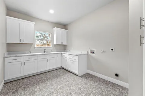 a kitchen with cabinets appliances and a window