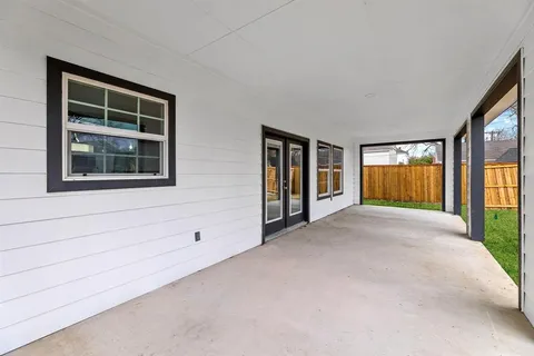 a view of an empty room with window and fireplace