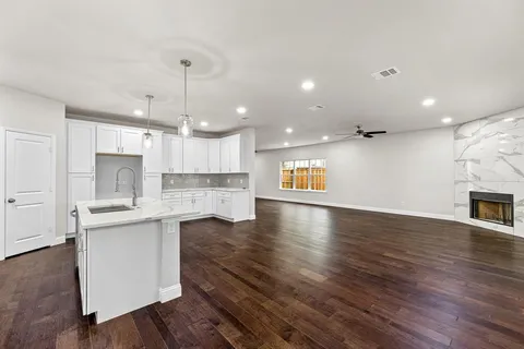 a view of kitchen with sink microwave and refrigerator