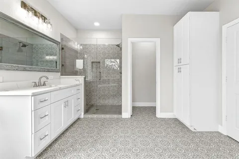 a bathroom with double vanity sink and a mirror