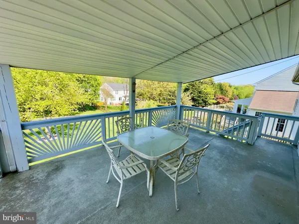 a view of a chairs and table in patio