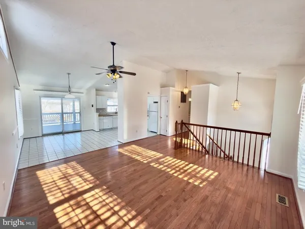 a very nice looking room with a large window and wooden floor