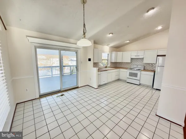 a open kitchen with cabinets and stainless steel appliances