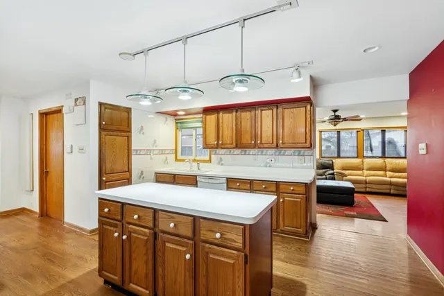 a kitchen with a sink cabinets and wooden floor