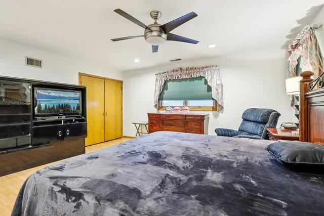 a bed room with a bed and a television