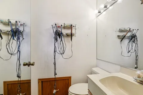 a bathroom with a granite countertop sink a toilet and shower