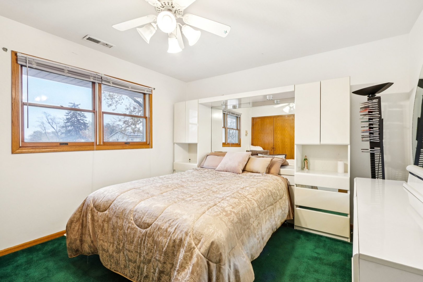 132 Tanglewood Drive Elk Grove Village, IL 60007 - Photo 26 of 42 a bedroom with a large bed and a chandelier