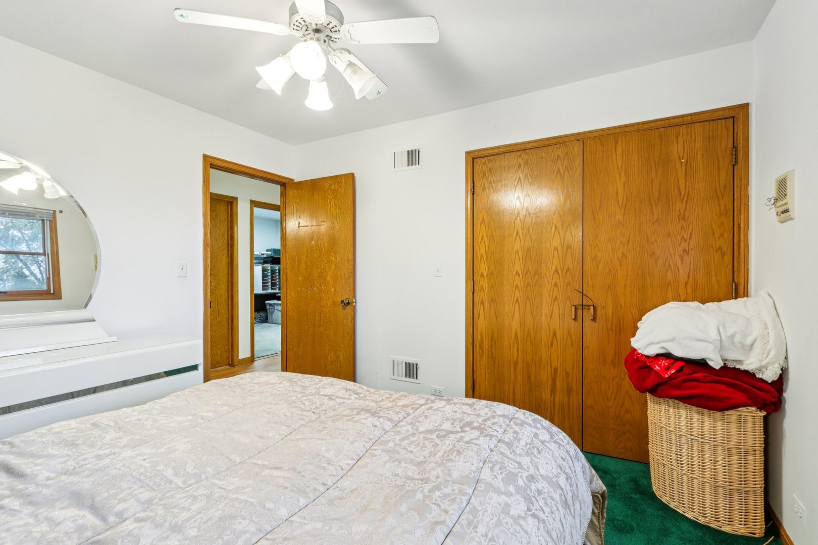 132 Tanglewood Drive Elk Grove Village, IL 60007 - Photo 27 of 42 a bedroom with a bed and a chandelier