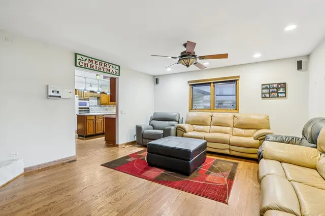 a living room with furniture kitchen view and a window