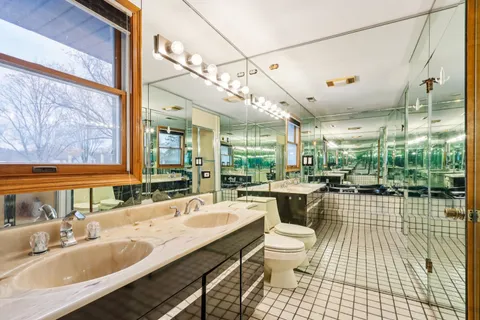 a view of a room with wooden floor and windows