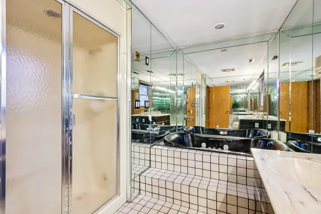 a view of a patio with a table and chairs and wooden fence